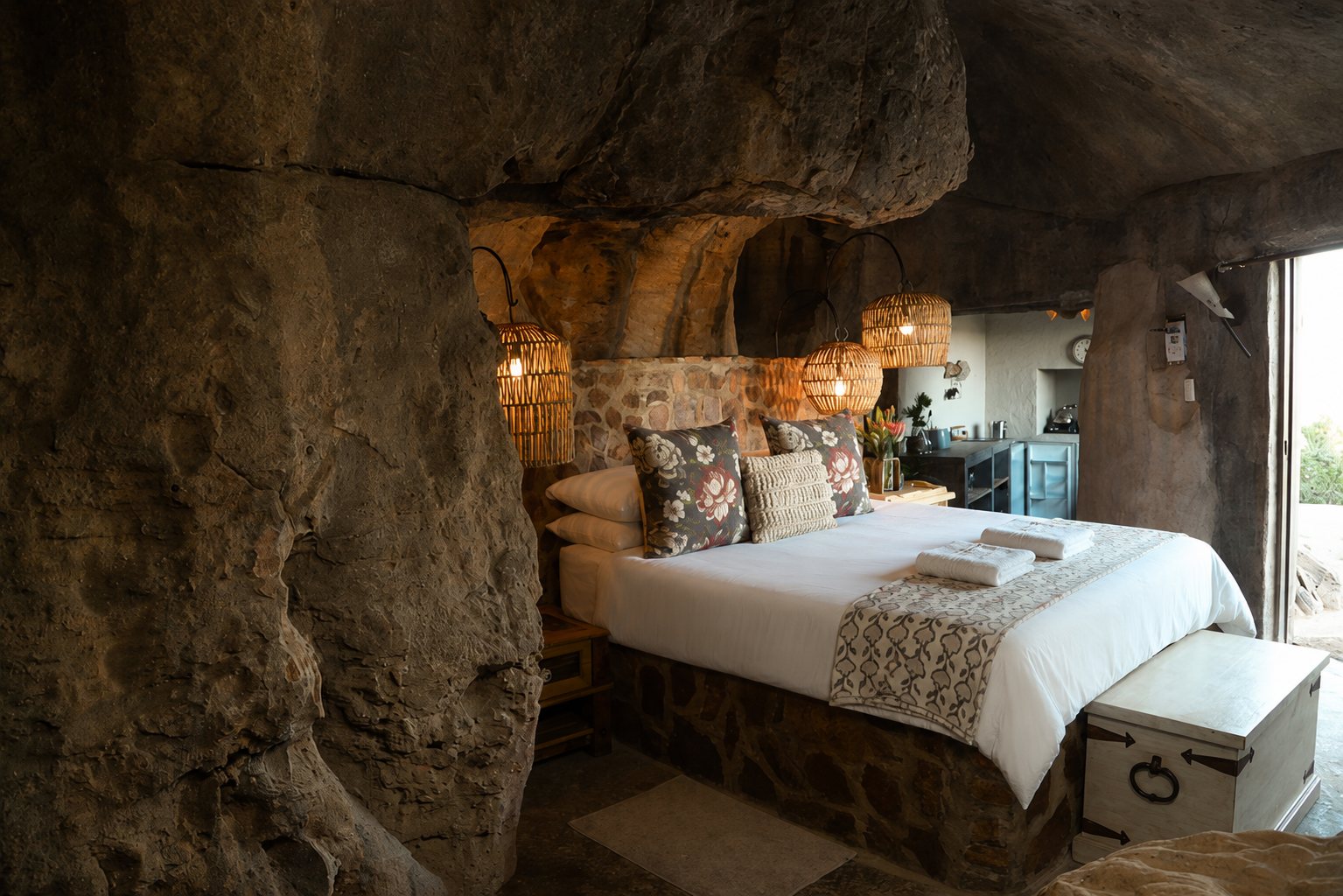 Stone-walled cave chalet bedroom at Donkieskraal