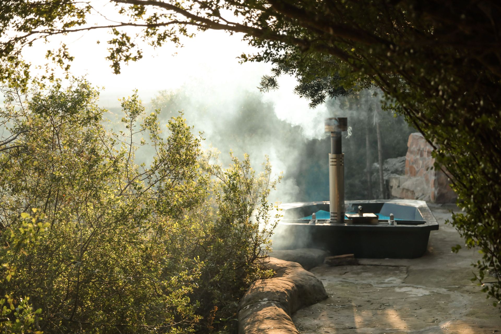 Private wood-fired hot tub beside a Donkieskraal cave chalet