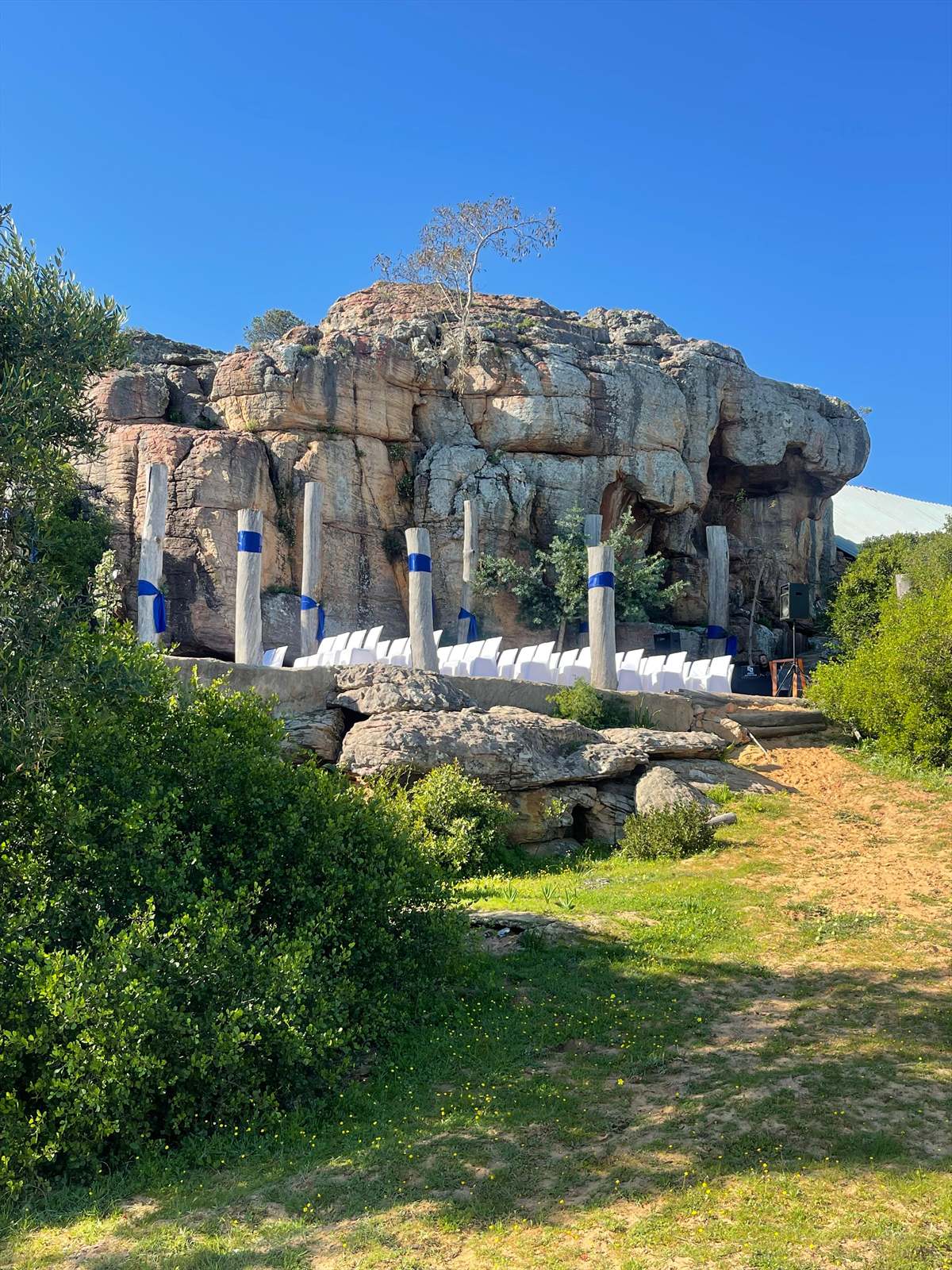 Outdoor wedding seating arranged below the sandstone rock venue at Donkieskraal